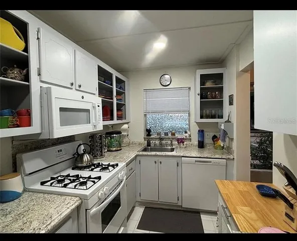 a kitchen with stainless steel appliances a stove a sink and a refrigerator