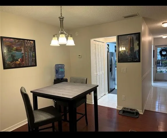 a dining room with furniture and wooden floor