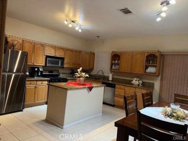 15542 Kiamichi Road Apple Valley, CA 92307 - Photo 12 of 39 a kitchen with kitchen island stainless steel appliances a stove refrigerator sink and microwave