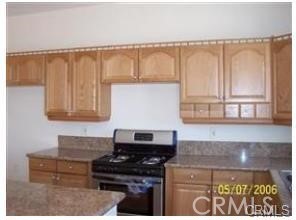 15542 Kiamichi Road Apple Valley, CA 92307 - Photo 14 of 39 a kitchen with a stove and a cabinet