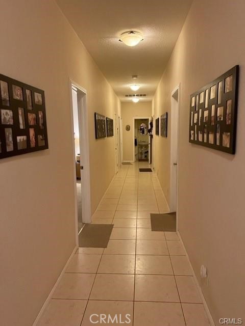 15542 Kiamichi Road Apple Valley, CA 92307 - Photo 16 of 39 a view of hallway with a large window and a kitchen