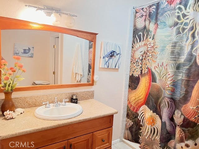 15542 Kiamichi Road Apple Valley, CA 92307 - Photo 17 of 39 a bathroom with a sink and a mirror