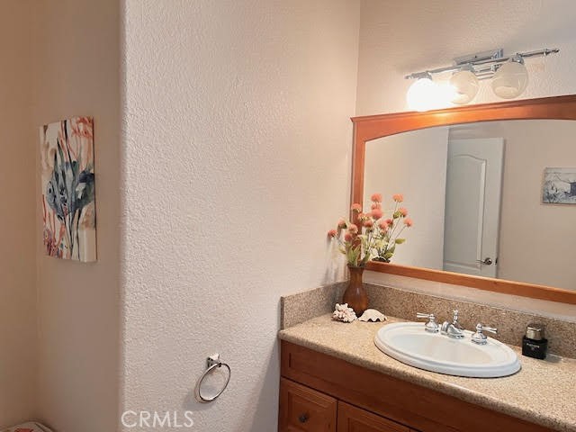 15542 Kiamichi Road Apple Valley, CA 92307 - Photo 18 of 39 a bathroom with a sink vanity and a mirror
