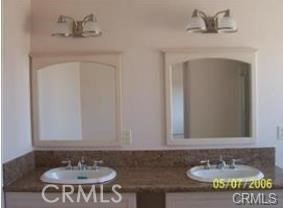 15542 Kiamichi Road Apple Valley, CA 92307 - Photo 26 of 39 a bathroom with a sink and a mirror