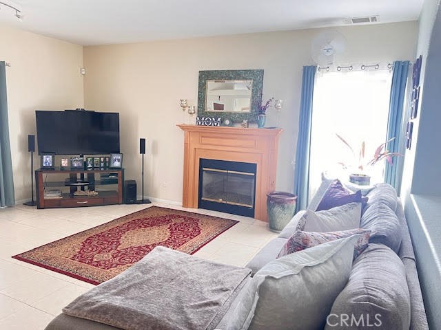 15542 Kiamichi Road Apple Valley, CA 92307 - Photo 8 of 39 a living room with furniture a window and a fireplace