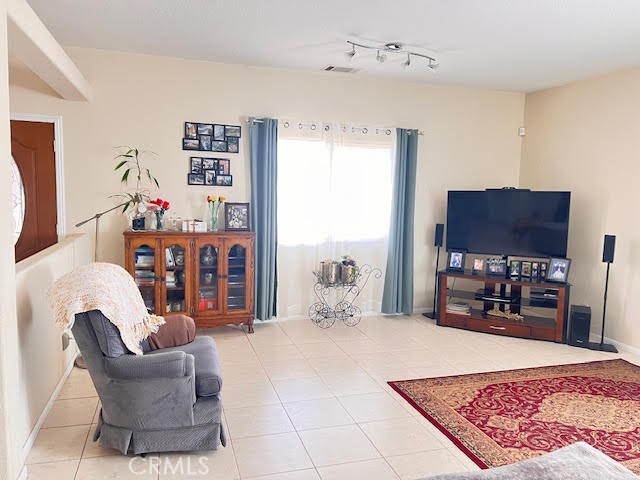 15542 Kiamichi Road Apple Valley, CA 92307 - Photo 9 of 39 a living room with furniture and a flat screen tv
