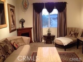 15542 Kiamichi Road Apple Valley, CA 92307 - Photo 10 of 39 a living room with furniture and a window