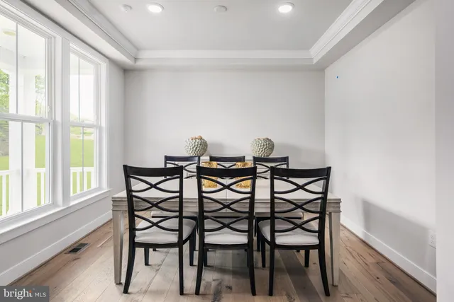 a view of a dining room with furniture and windows