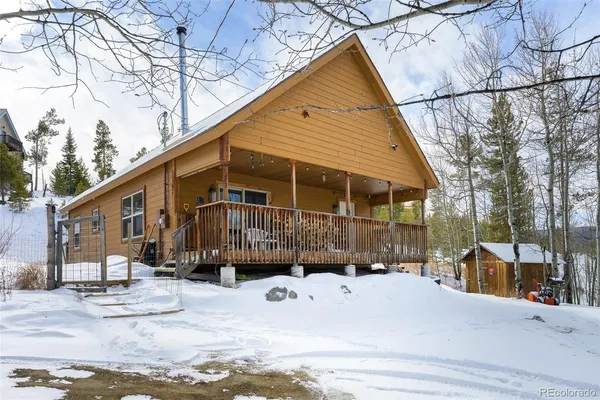 a front view of a house with a yard covered in snow