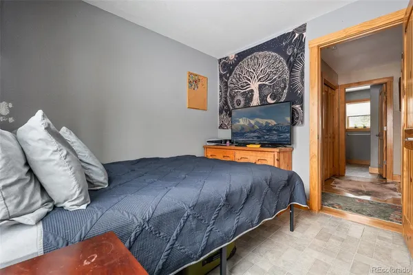 a bedroom with a bed and dresser