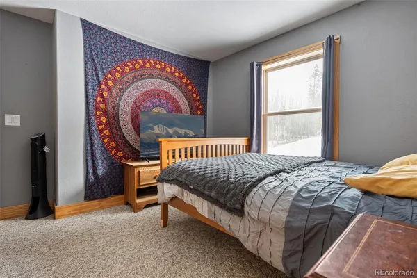 a bed sitting in a bedroom next to a window