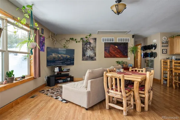 a living room with furniture a flat screen tv and a large window