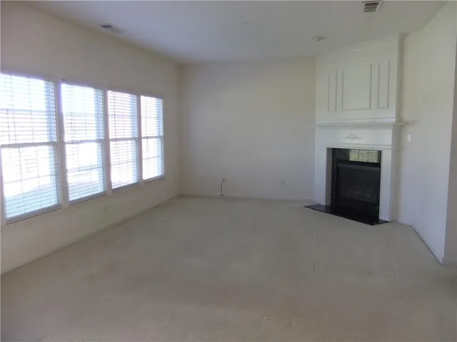 an empty room with a fireplace