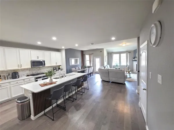 a kitchen with a sink appliances and cabinets