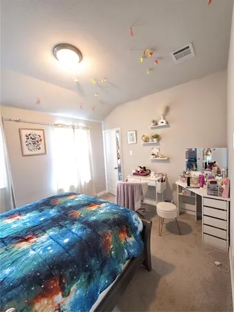 a bedroom with a bed and window