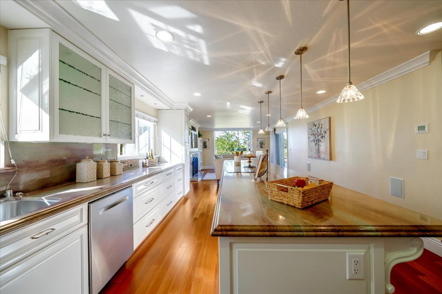 475 Winged Foot Road Half Moon Bay, CA 94019 - Photo 14 of 28 a kitchen with counter top space and wooden floor