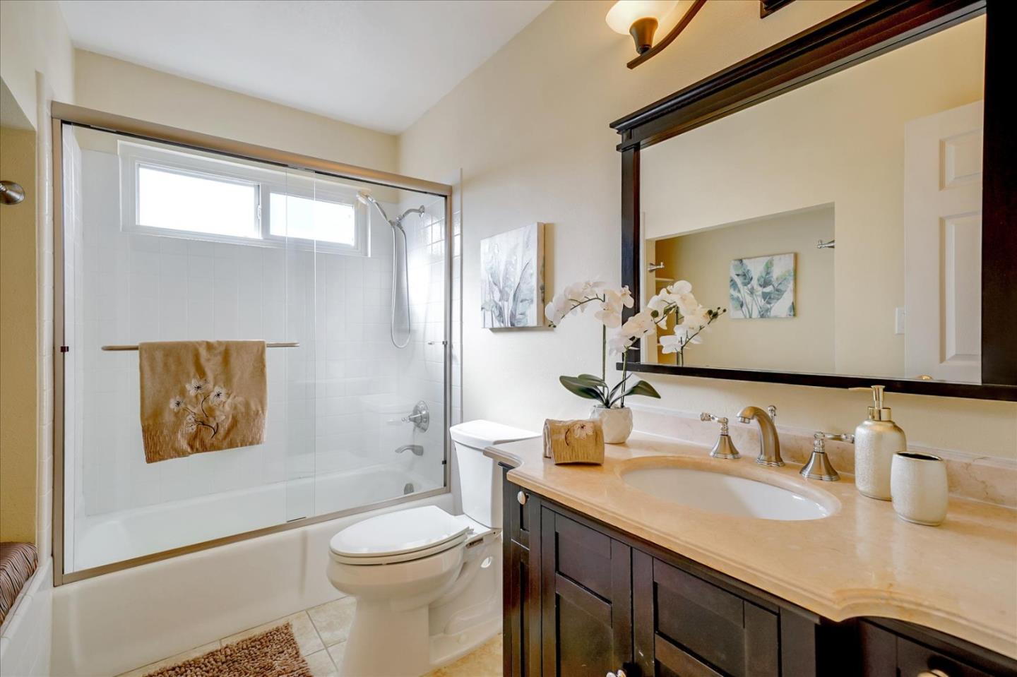 475 Winged Foot Road Half Moon Bay, CA 94019 - Photo 18 of 28 a bathroom with a granite countertop sink mirror vanity and toilet