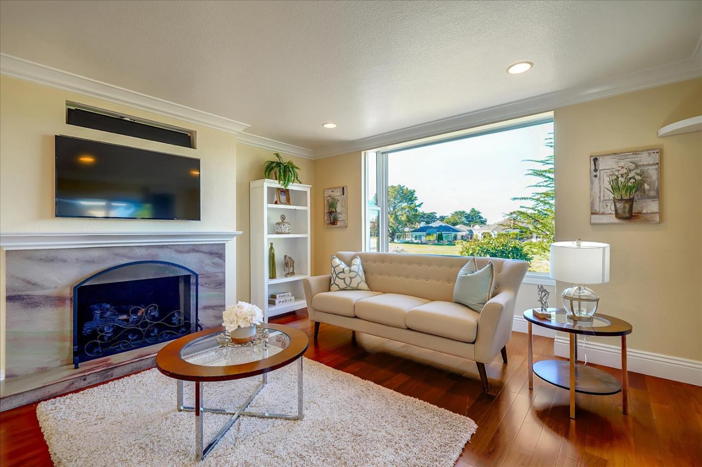 475 Winged Foot Road Half Moon Bay, CA 94019 - Photo 9 of 28 a living room with furniture a flat screen tv and a fireplace