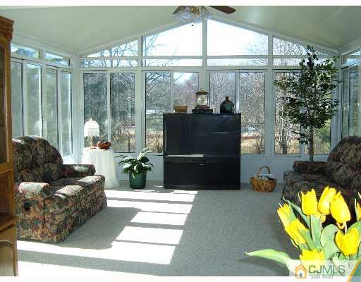11 Montview Road Edison, NJ 08837 - Photo 2 of 8 a living room with furniture and a floor to ceiling window