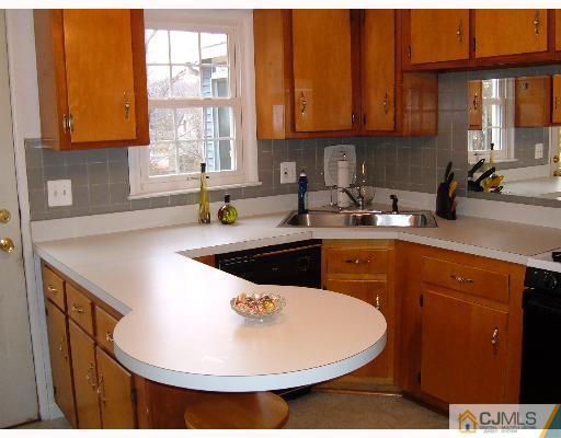 11 Montview Road Edison, NJ 08837 - Photo 3 of 8 a kitchen with a sink a stove and cabinets