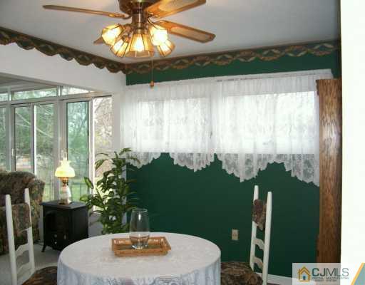 11 Montview Road Edison, NJ 08837 - Photo 5 of 8 a vase of flowers sitting on a table with a fireplace
