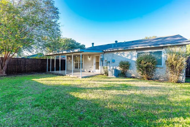 a view of a house with a yard and sitting area