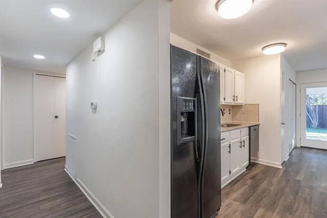 a view of hallway with wooden floor