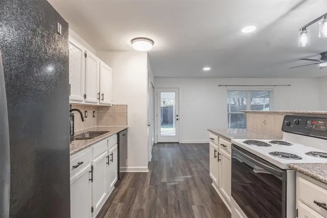 a kitchen with a stove top oven sink and cabinets