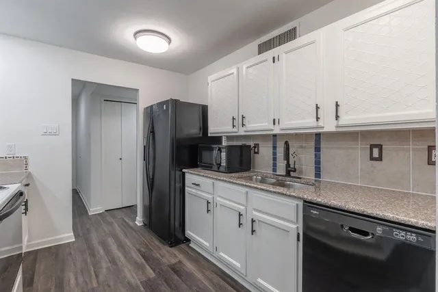 a kitchen with a sink stainless steel appliances and cabinets