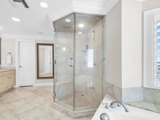 a bathroom with bathtub and window