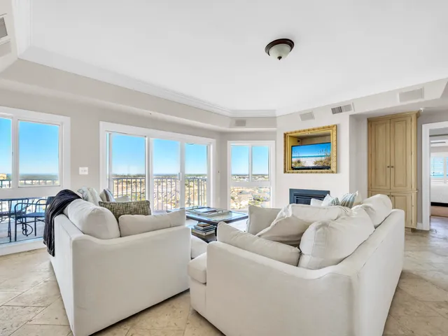 a living room with furniture and large windows