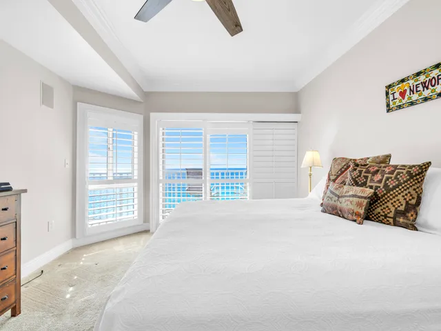 a bathroom with a granite countertop sink a mirror a potted plant and a shower