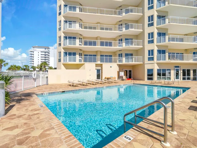 a swimming pool with outdoor seating and yard