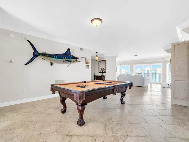 a room with furniture pool table and projector