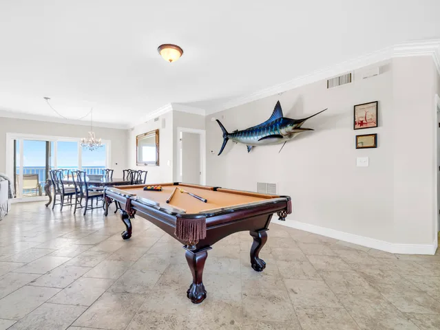 a room with furniture and pool table