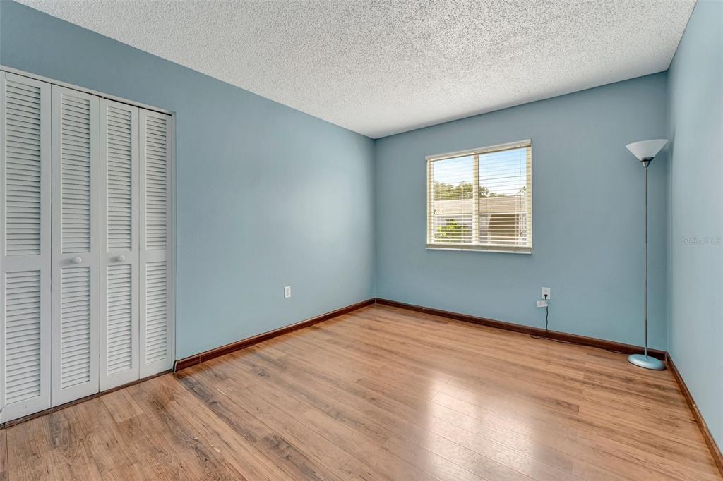 13300 Walsingham Road, Unit 56 Largo, FL 33774 - Photo 26 of 35 a view of an empty room with wooden floor and a window