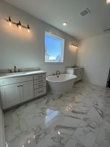 a bathroom with a sink mirror toilet and bathtub