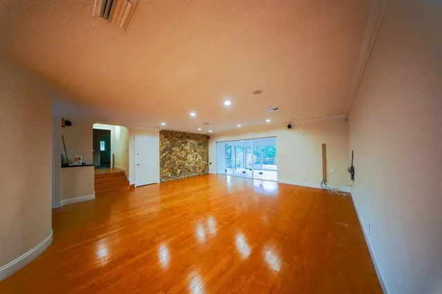 a large kitchen with stainless steel appliances kitchen island a large counter top that has a couch