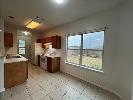 a kitchen with stainless steel appliances a refrigerator and cabinets