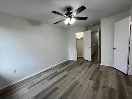 a bathroom with a toilet sink vanity granite and shower