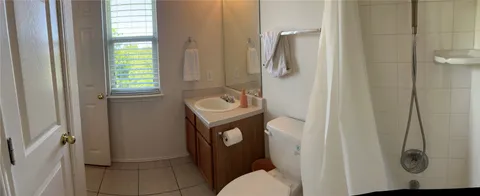 a bathroom with a granite countertop shower and a sink
