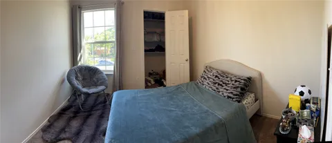 a bedroom with a bed and a chair