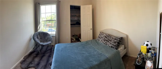 a bedroom with a bed and a chair