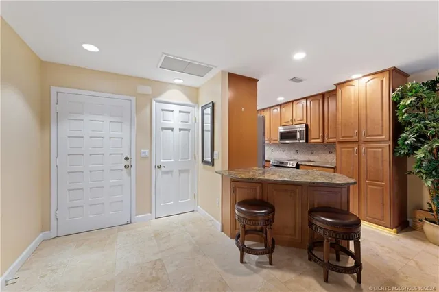a kitchen with a refrigerator and a sink