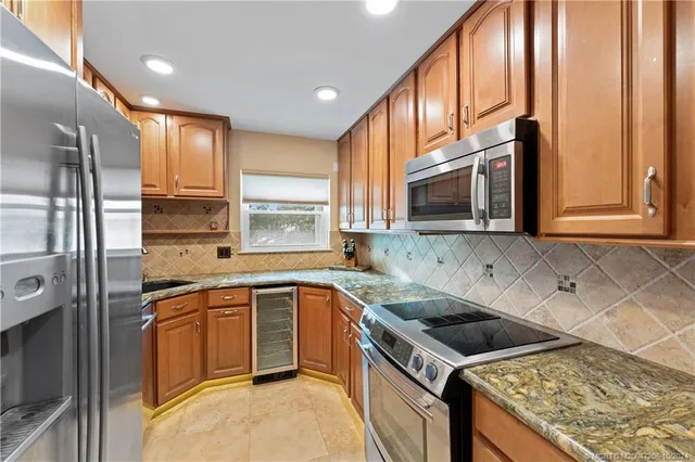a kitchen that has a sink a stove and cabinets