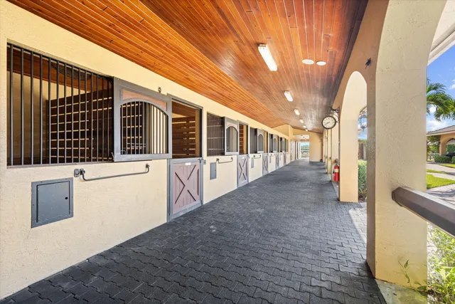 a view of a porch with wooden floor and fence