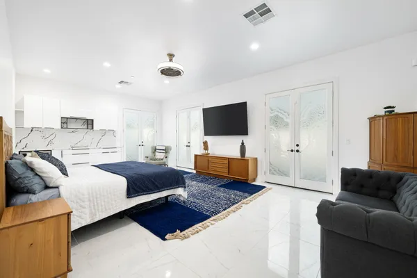a bedroom with furniture and a flat screen tv