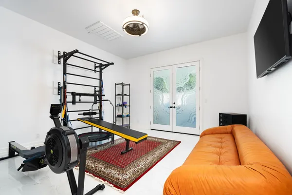 a bedroom with a bed and a flat screen tv