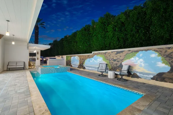 a view of a backyard with sitting area