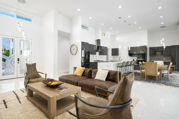 a living room with furniture and kitchen view